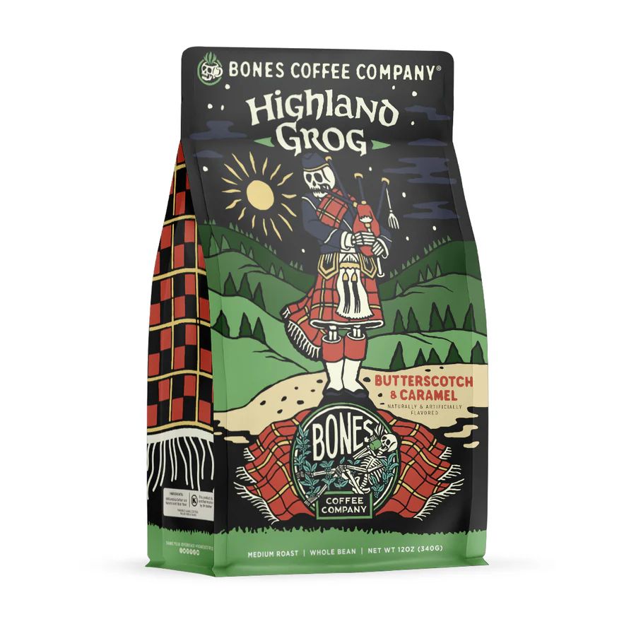 Image of a bag of Bones Coffee Company Highland Grog (Butterscotch & Caramel). Bag features a drawing of a skeleton in full red tartan regalia playing bagpipes in the Scottish highlands under a dark sky