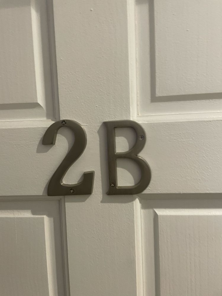 A door with metal letters "2B" on it.