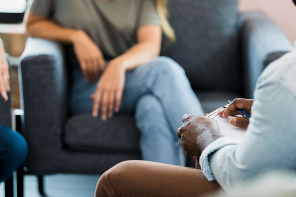 Detail of people in a mediation session.