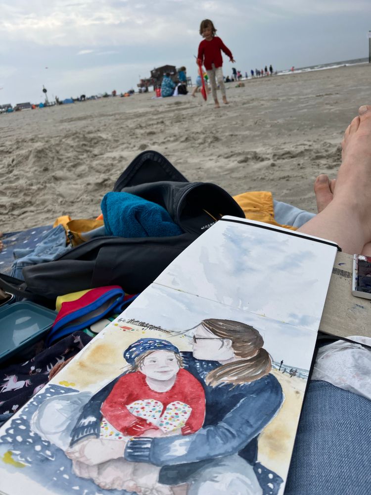 Open sketchbook at the beach showing Andrea and Martha