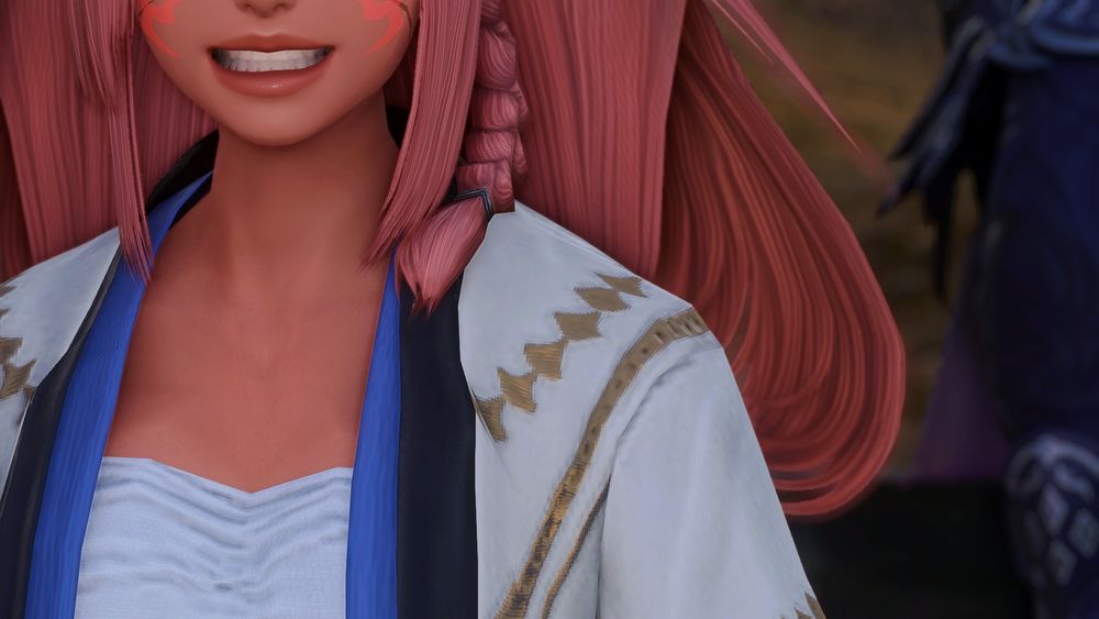 A close-up of Bris(?) but her eyes are out of frame, and she has a wide, unsettling grin.