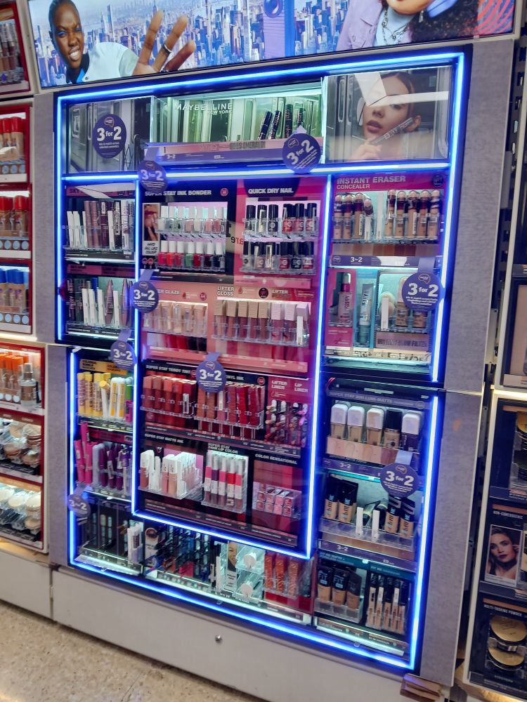 Blue LED neon style lighting in makeup section of Sainsbury's, Sale, UK