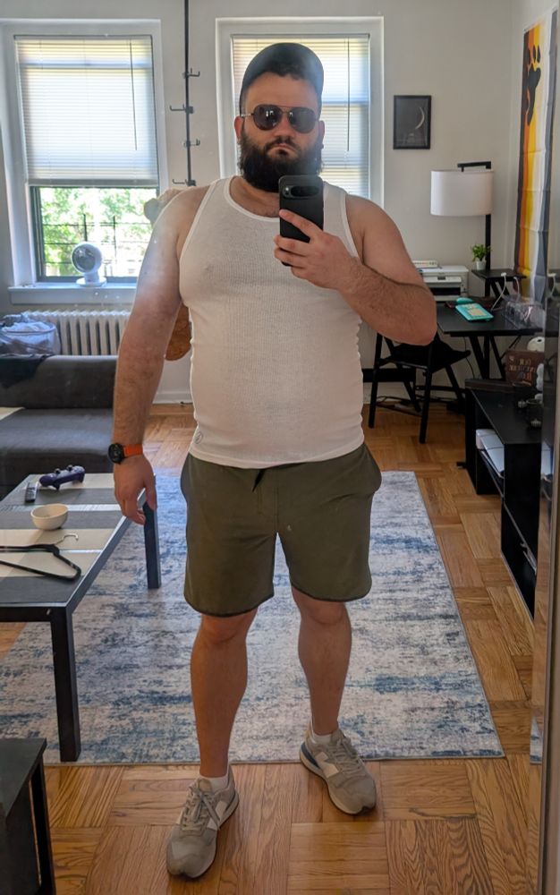 Big bear man with beard in glasses and in a hat