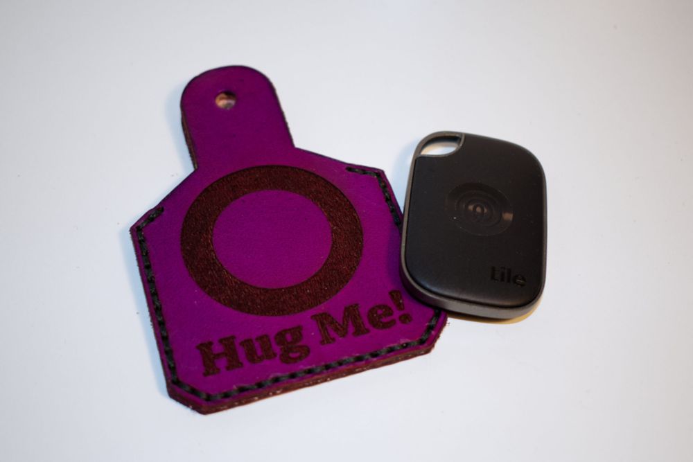 The Ear Tag is a leather ear tag designed for use on fursuits. It has a pocket to hold an air tag or tile tracker to help keep connected with a handler or just to help not lose a fursuit head! 

It can be installed like a piercing on a fursuit ear or even worn like a real earring on a human ear with the optional over ear loop.

Text and icons on either side of the tag are customizable