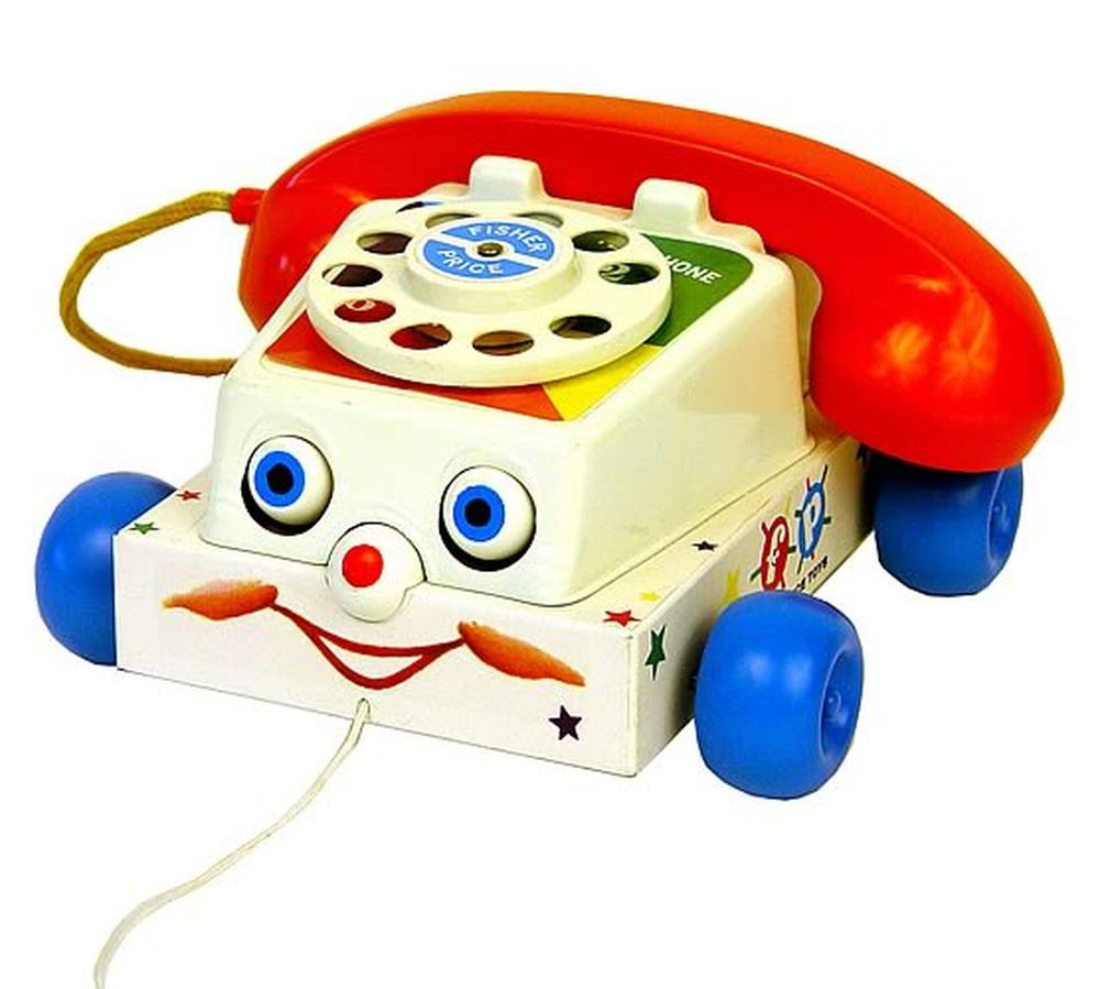 Picture of a Fisher Price toy phone with googly type eyes and a red button on it's nose. 