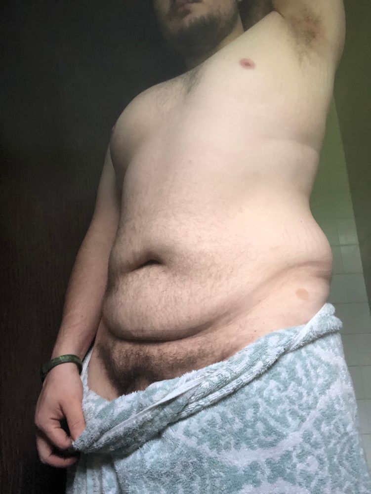 Shot of my torso chest and armpit with my arm raised. I’m wrapped in a towel at my waist but I’m pulling at it so my bush is exposed 