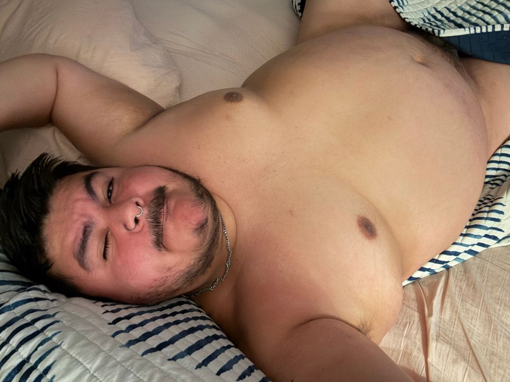 Photo of myself laying on the bed naked with the comforter covering my groin 