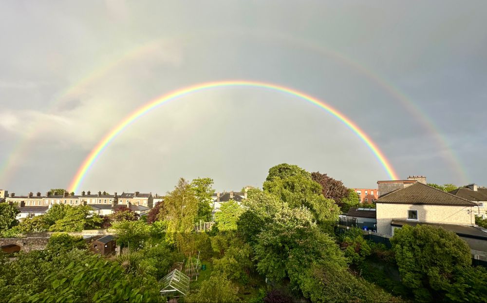 Double rainbow! Houses and trees in foreground.