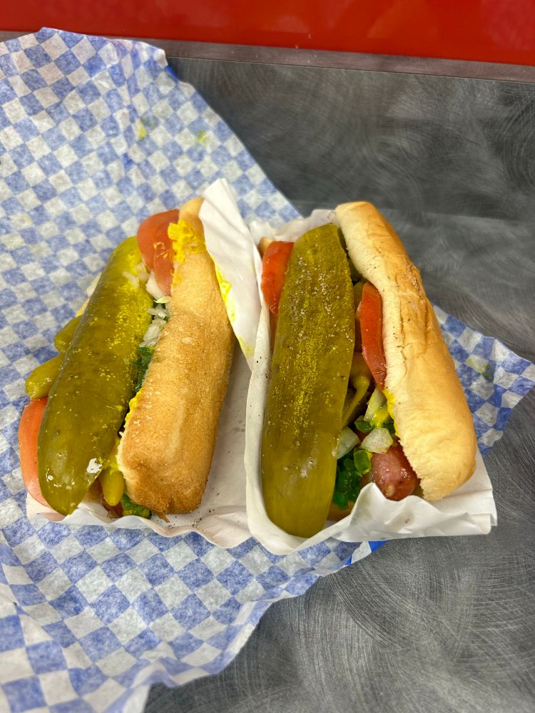 Two Chicago hot dogs with the fixings