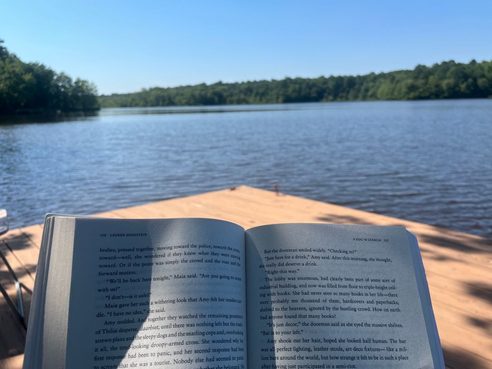 Reading a book on a dock at the lake