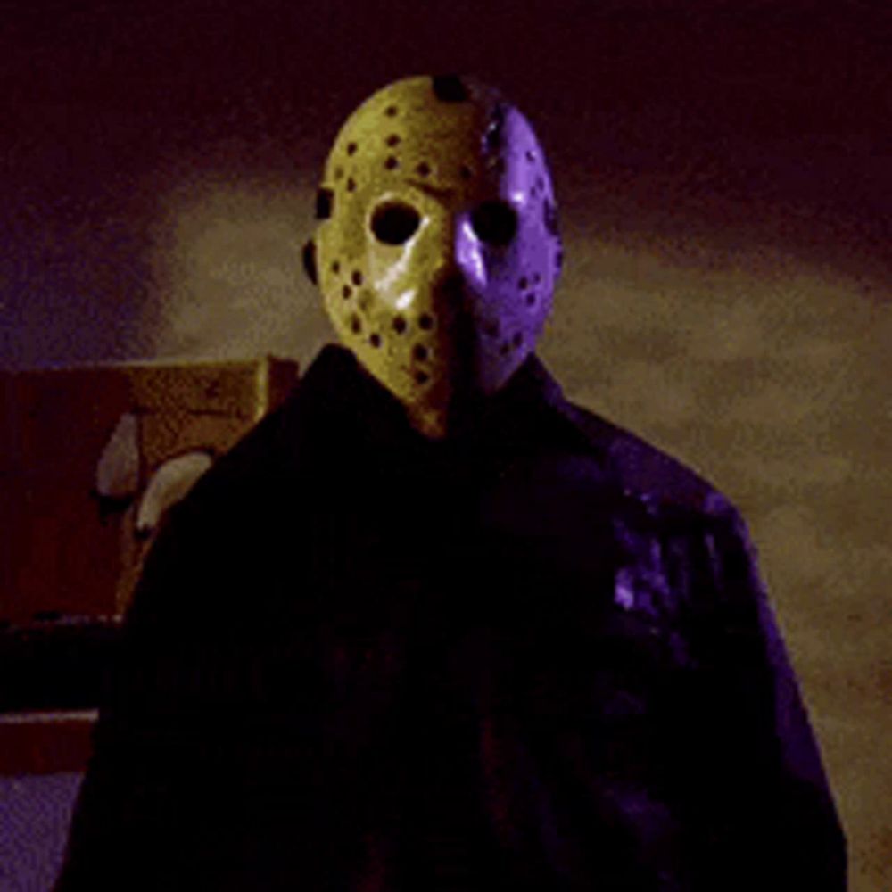 a person wearing a jason voorhees mask and black jacket