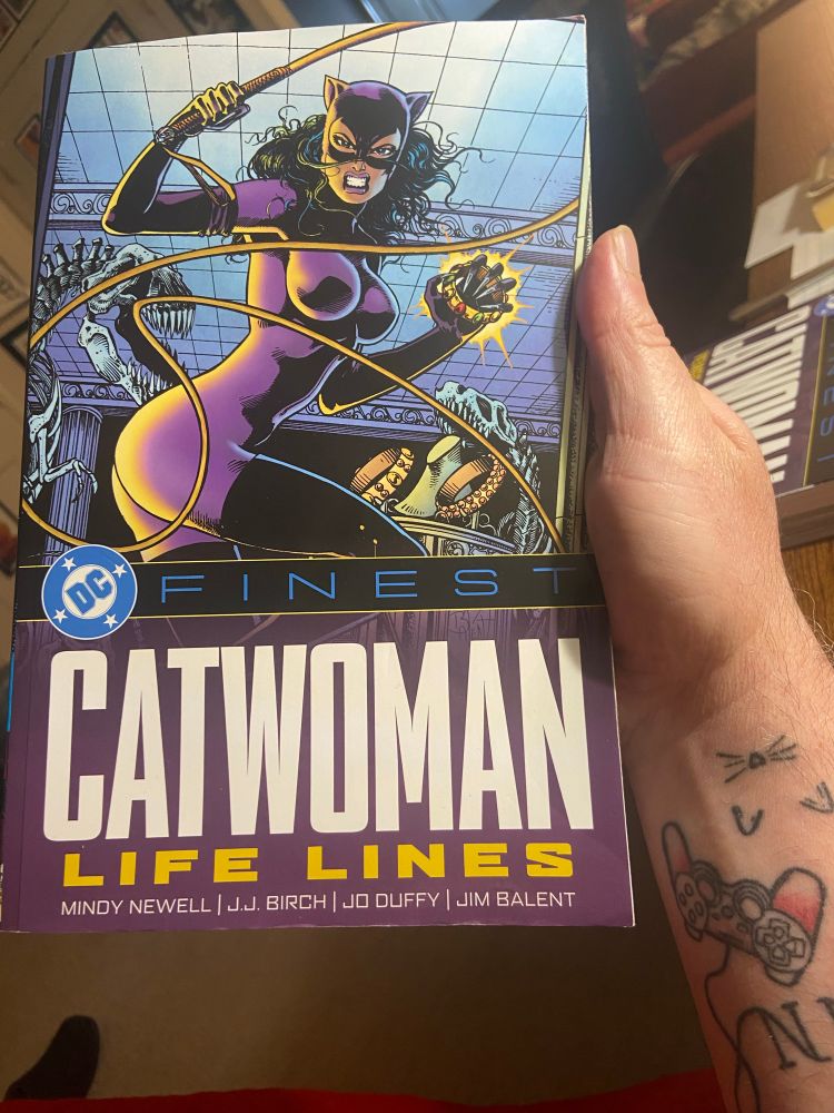 Catwoman: Life Lines trade paperback with catwoman on the cover in her purple outfit, with whip and jewels 
