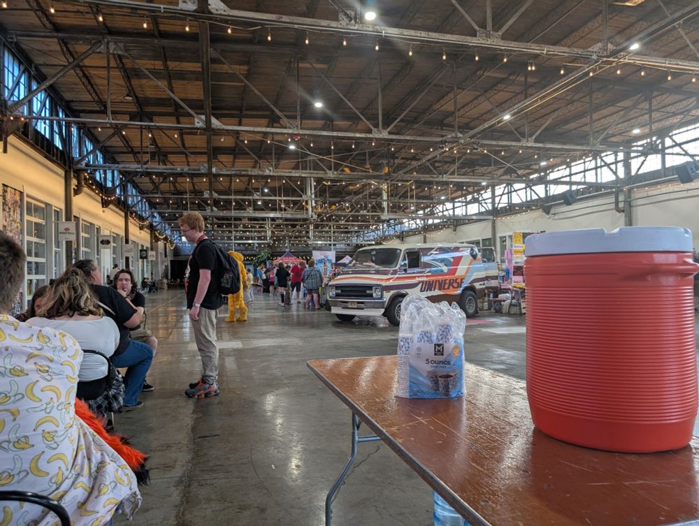 A photo of a convention center with merchant stalls set up