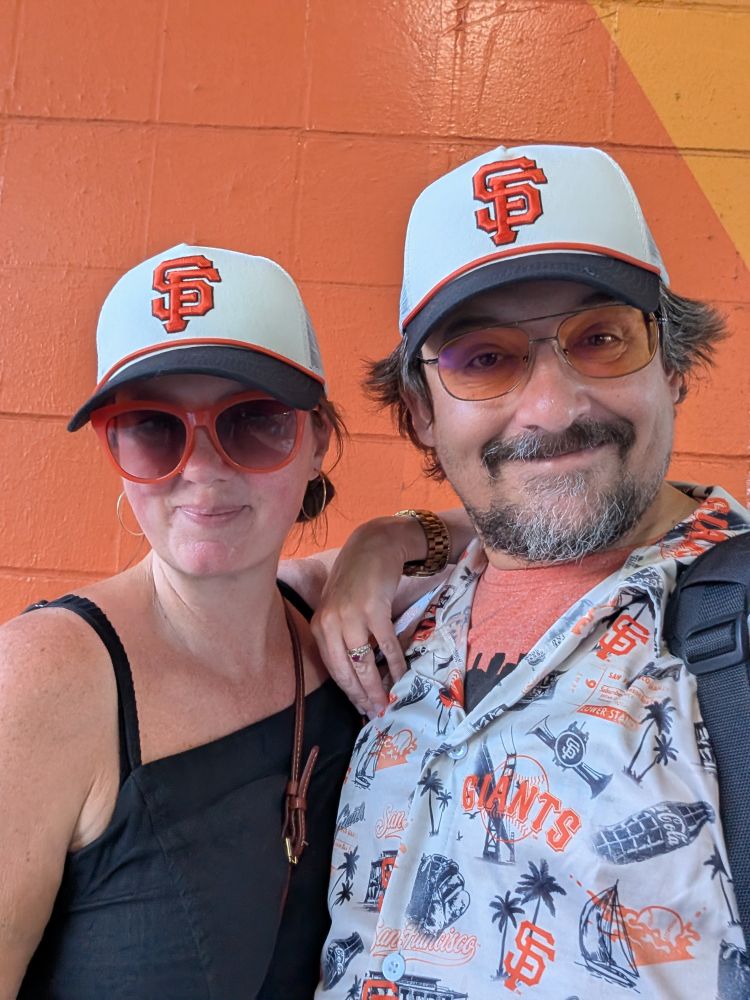 Two SF Giants fans adorned in today's giveaway rope hat
