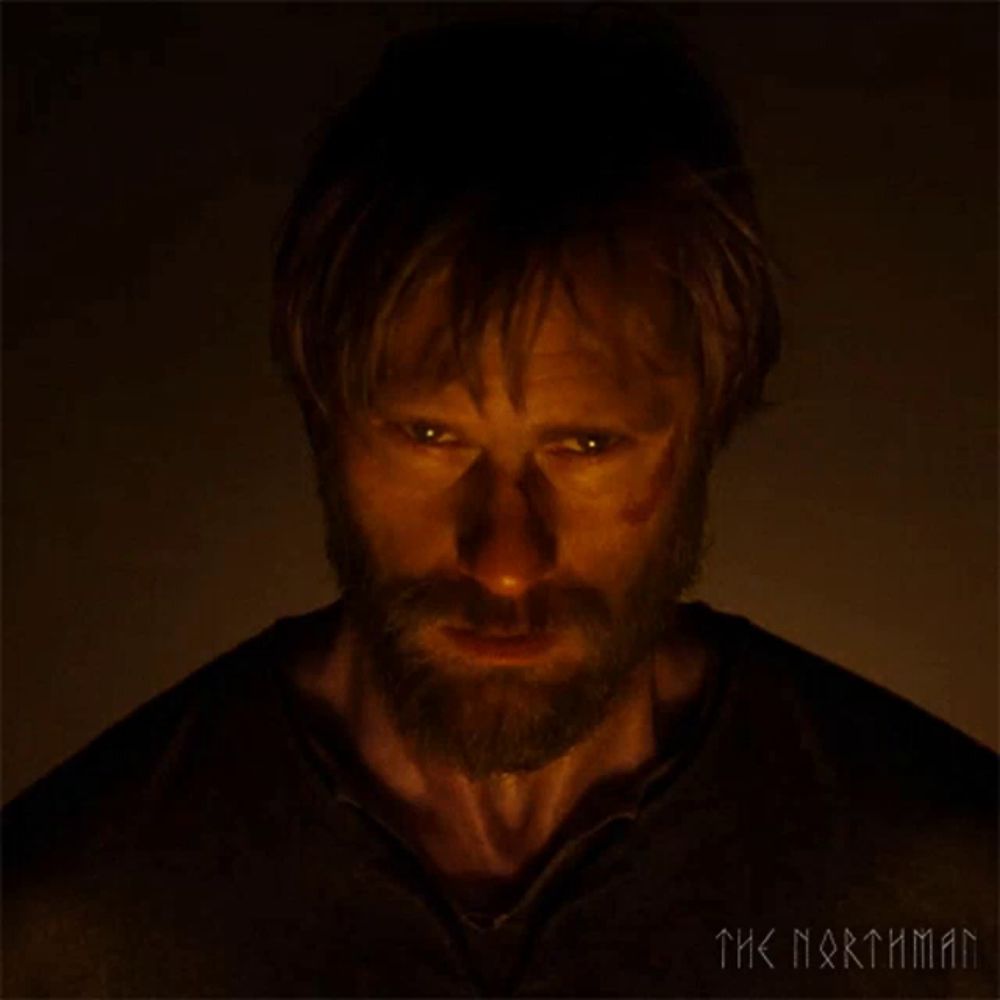 a man with a beard is looking at the camera with the words the northman behind him