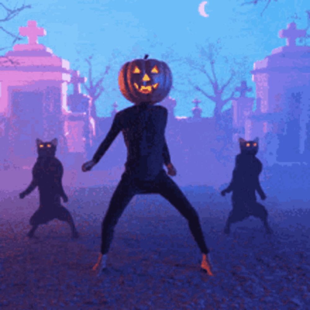 a man with a pumpkin on his head is surrounded by cats