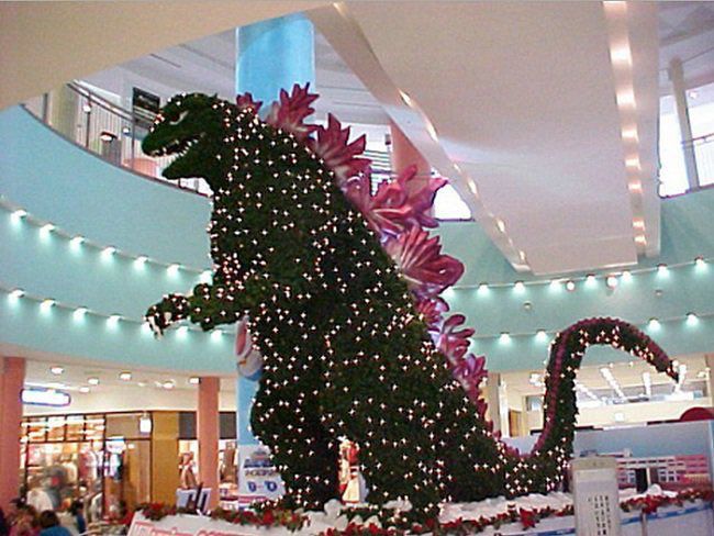image of a two-story Godzilla shaped Christmas tree covered in white lights in a Japanese mall