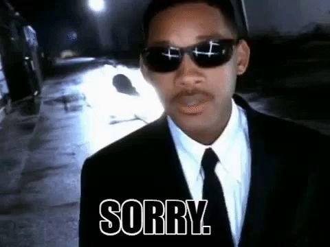 a man in a suit and tie with sunglasses says sorry .