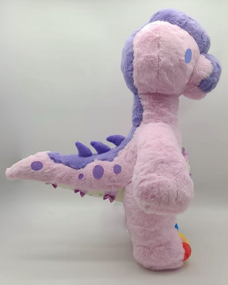 Photo of a plush dinosaur from the Rawrcade plush series. Confetti the giraffatitan, side view. 