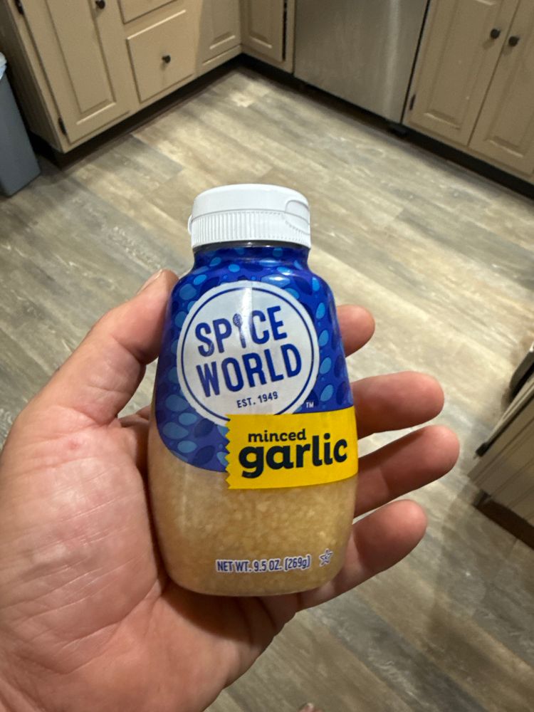 A squeeze bottle of minced garlic I bought for a camping trip this summer that my partner won’t let me throw away. 