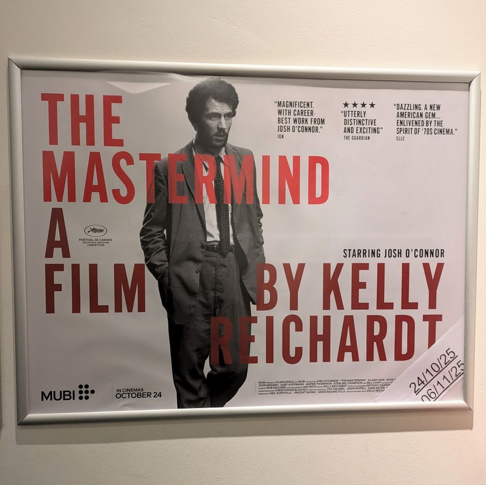 Cinema poster of The Mastermind, a film by Kelly Reichardt, with single image of Josh O'Connor in a suit