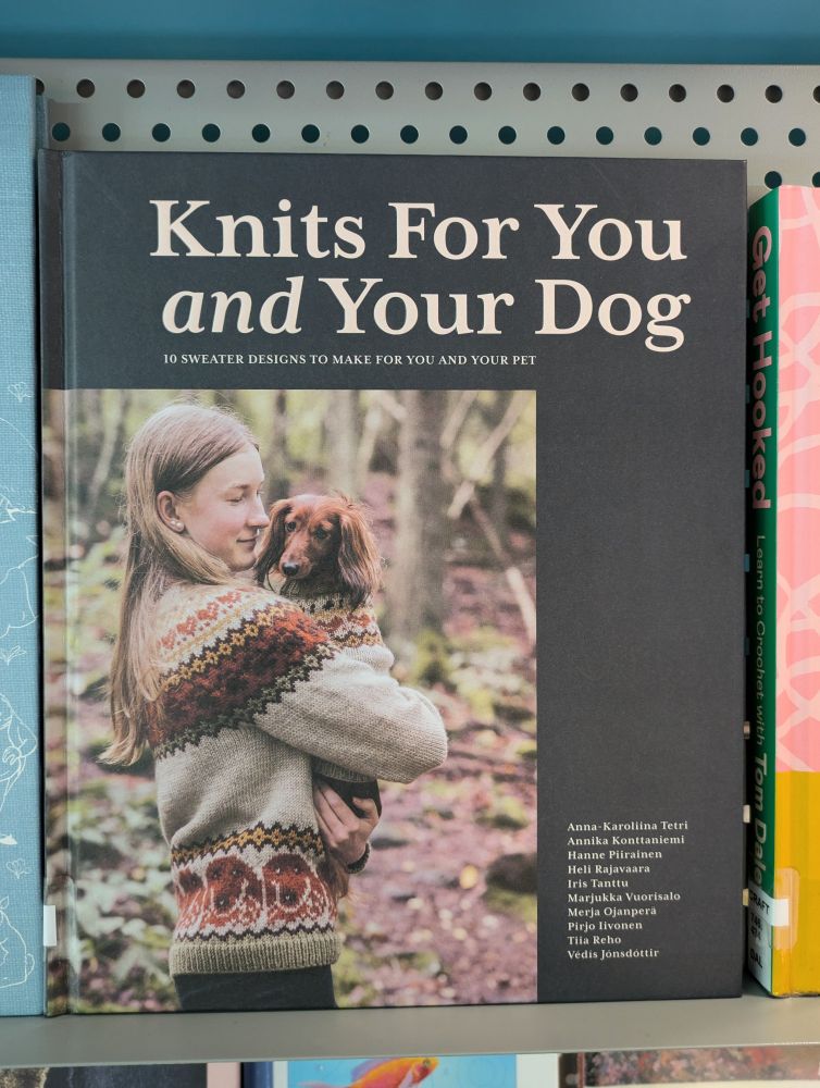 Hardback cover of Knits for you and your dog, with picture showing girl holding dachshund, both in matching jumpers 