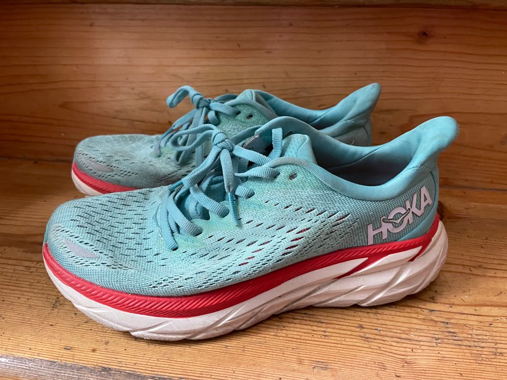 Pair of turquoise and red Hoka trainers