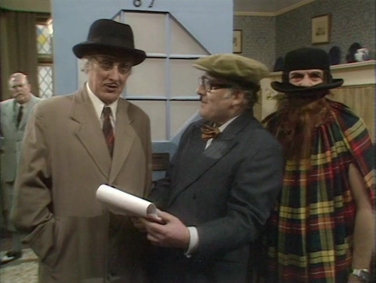 Spike Milligan and Alan Clare wearing hats, alongside a hat wearing John Bluthal. From Spike's Q series.