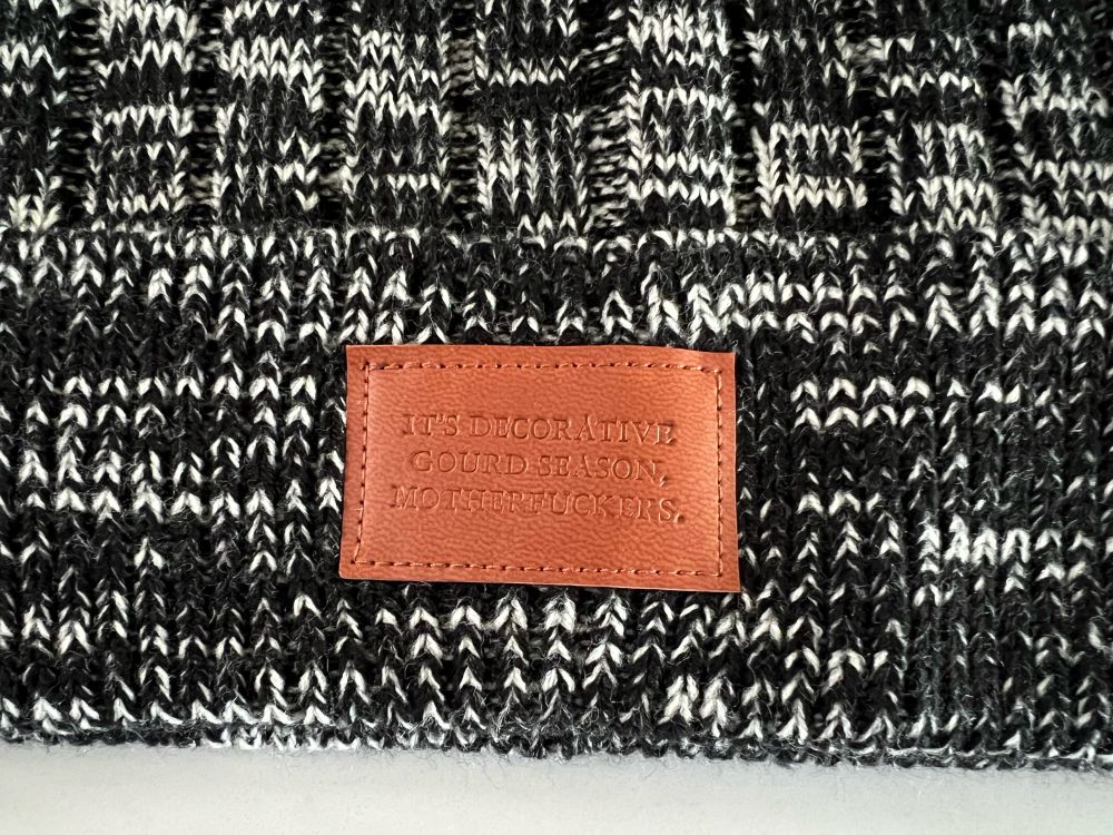Close-up of label on beanie: “It’s decorative gourd season, motherfuckers”