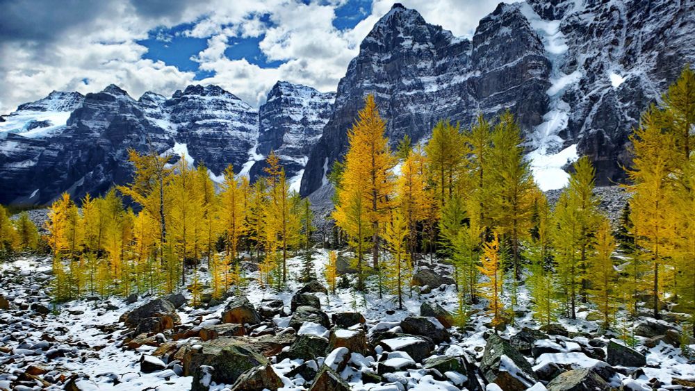 Valley of the Ten Peaks is a valley in Banff National Park in Alberta, Canada, which is crowned by ten notable peaks and also includes Moraine Lake. The valley can be reached by following the Moraine Lake road near Lake Louise. The ten peaks were originally named by Samuel Allen, an early explorer of the region, who simply referred to them by using the numerals from one to ten in the Stoney First Nations Language. He may have learned the terms from his Native American guides, who helped him with the horses. The Nakoda–also known as the Stoney Indians–is a tribe whose culture and dialect are closely related to that of the Assiniboine First Nation, from whom they are believed to have separated in the mid-1700s, and who roamed large parts of the prairies and mountains of western Alberta well into British Columbia. The secluded Valley of the Ten Peaks was part of their original homeland. Gradually, though, all but three of the mountains were renamed in honour of noteworthy individuals, including Allen himself. 