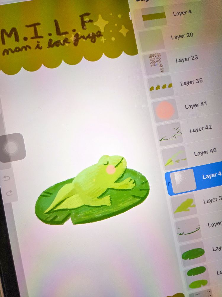 A photo of Ronnie's iPad screen. The drawing app Procreate is open, and it shows a sticker sheet drawing in progress. Ronnie has used a crayon like brush to draw a frogglet on a lilypad.