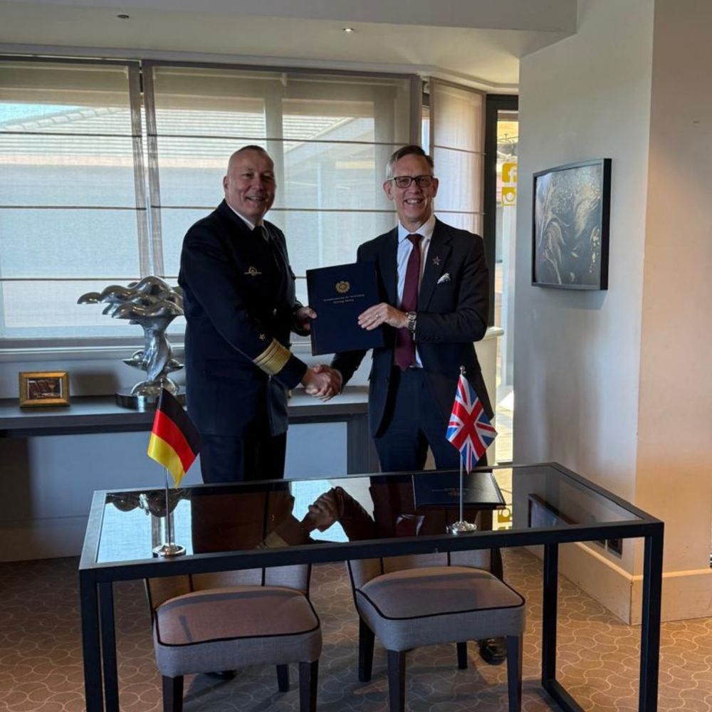 UK National Armaments Director and German National Armaments Director shake hands after signing a Letter of Intent