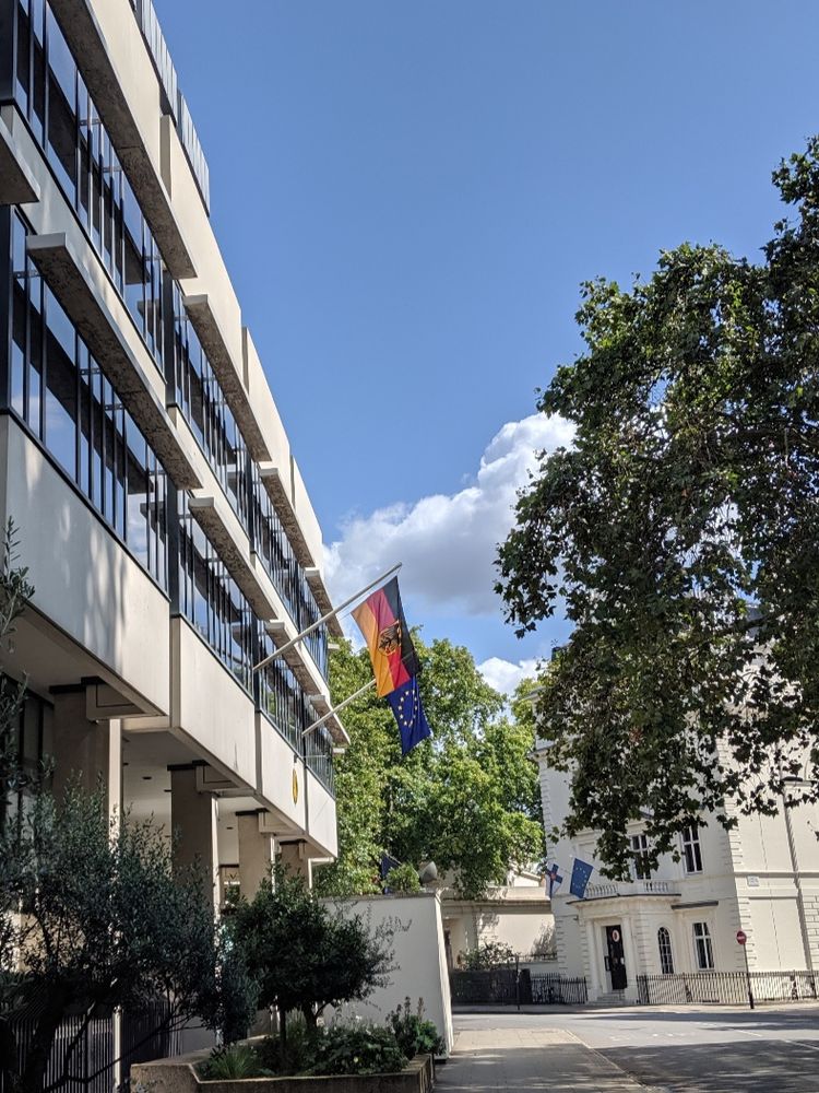 Picture of the German Embassy London, taken from the street, flags of Germany and the European Union are hanging on the outside of the building.