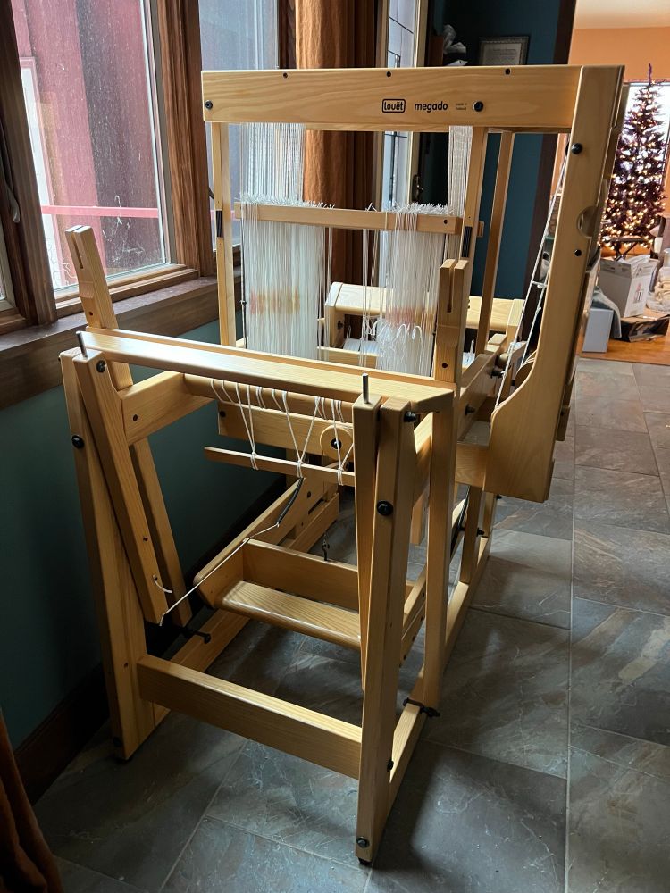 Front view of a loom in a large entryway of a home. It currently does not have the breast beam or the top of the beater.