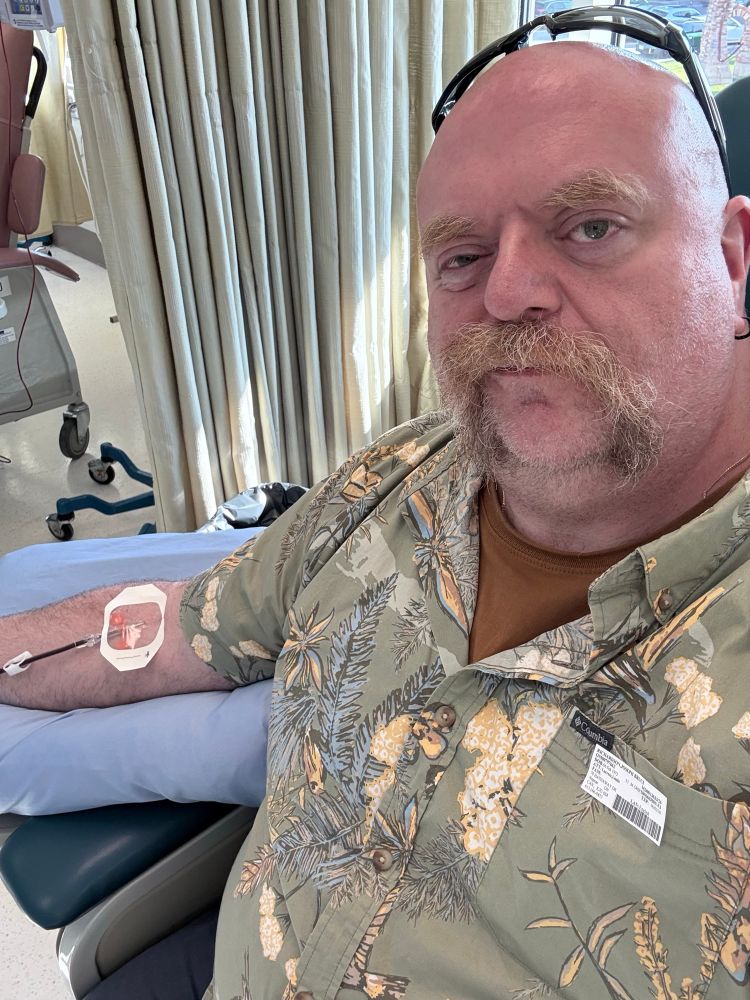 Man sitting down getting blood drawn