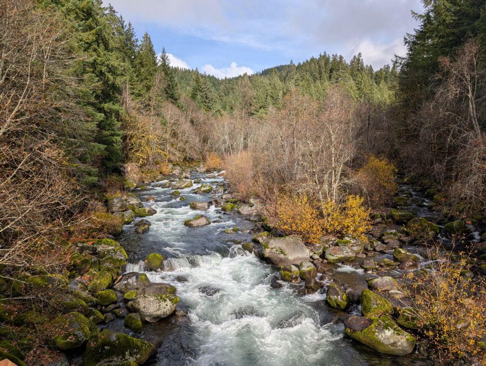 A mountain river Cascades down through boulders 