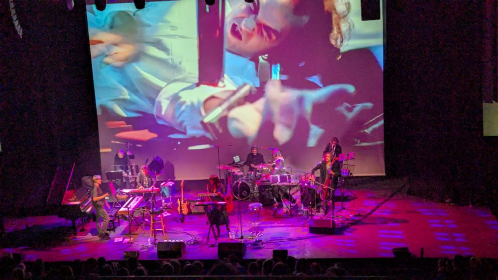 Simon Boswell and band live on stage.