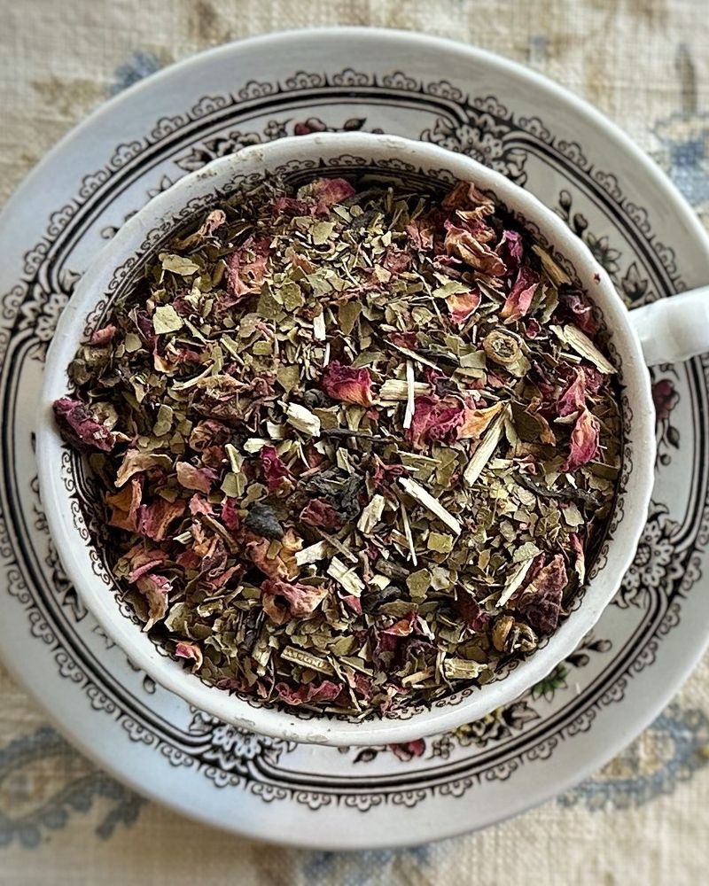 Teacup full of yerba mate, rose, and herbs