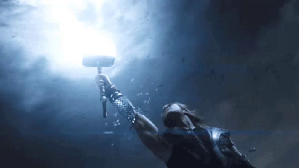 a man is holding a hammer in the air with a light coming out of it