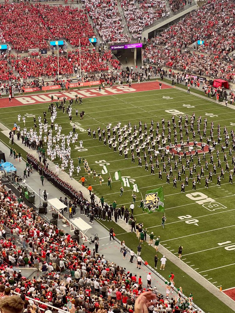 The Ohio Bobcats football team runs onto the field at Ohio Stadium while the OSUMB is on the field in a pregame block.

The one thing that pisses me off to no end is how much Ohio State co-opts just “Ohio” in literally a majority of their branding and promotion. I intentionally tried to capture our cheerleaders running with flags spelling OHIO here because the OSU cheerleaders had their own exact flags like this (except red) that they ran out with only a minute or so prior. I go a little too hard sometimes in my love for being a Bobcat but I will never apologize for defending “Ohio” as OUr name, not theirs.