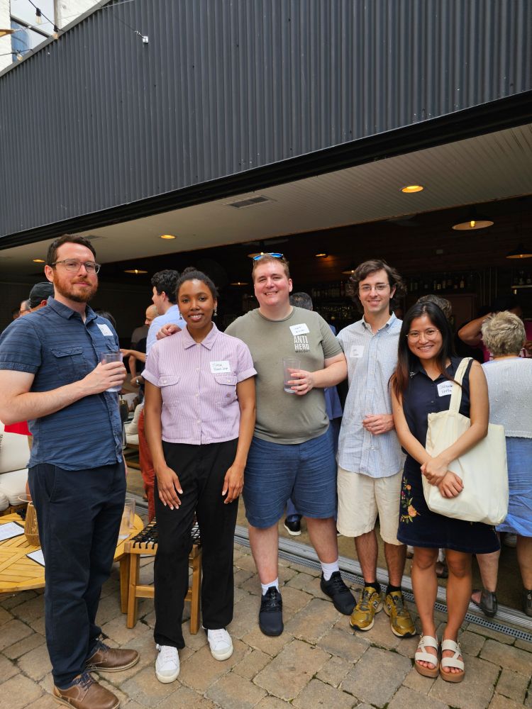 Members of 1st Ward United posing for a photo at an outdoor patio 
