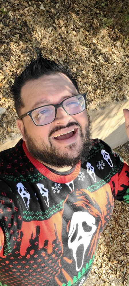 Nerd man in ghostface christmas sweater