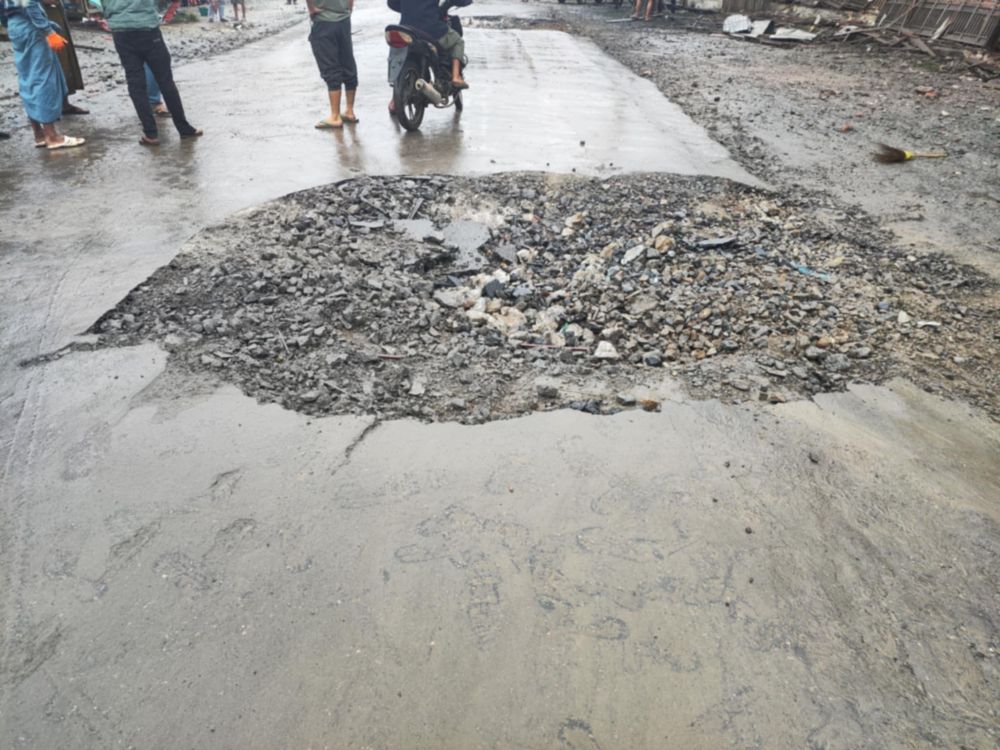 Residents of Mogok Township, Mandalay Region, inspect the damage caused by an airstrike on Aug. 2. (Credit: TNLA)