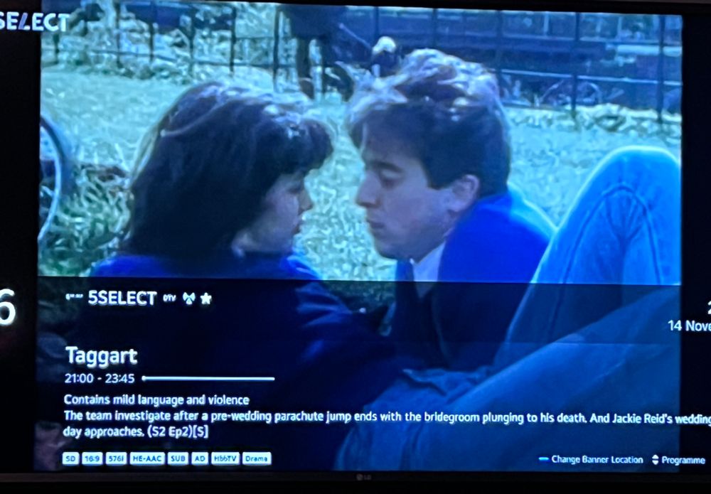 Photo of my telly showing Alan Cummings and Julie Graham in a 1986 Taggart about to have a snog in Kelvingrove park, and an EPG listing for an episode in 2001 about Jackie Reid (who hasn’t yet been in the show) getting married.