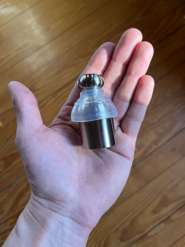 Stealth Retainer stainless steel Extended P-Tainer (+25mm size) held in hand for size reference.
