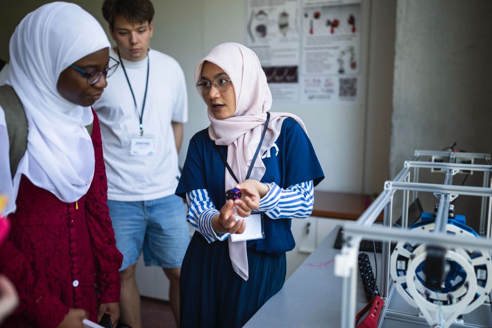 Robotics engineer Puspita Triana Dewi shows visitors a robot built from 3D-printed, stackable segments that link together to form a flexible spine.

