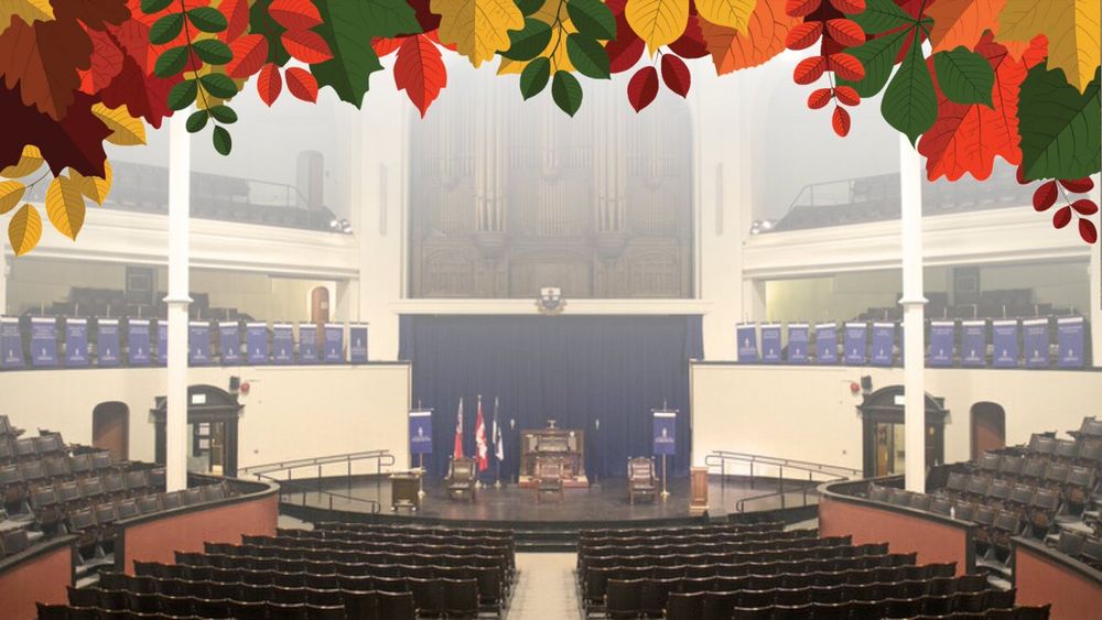 Inside empty convocation hall with banners.
