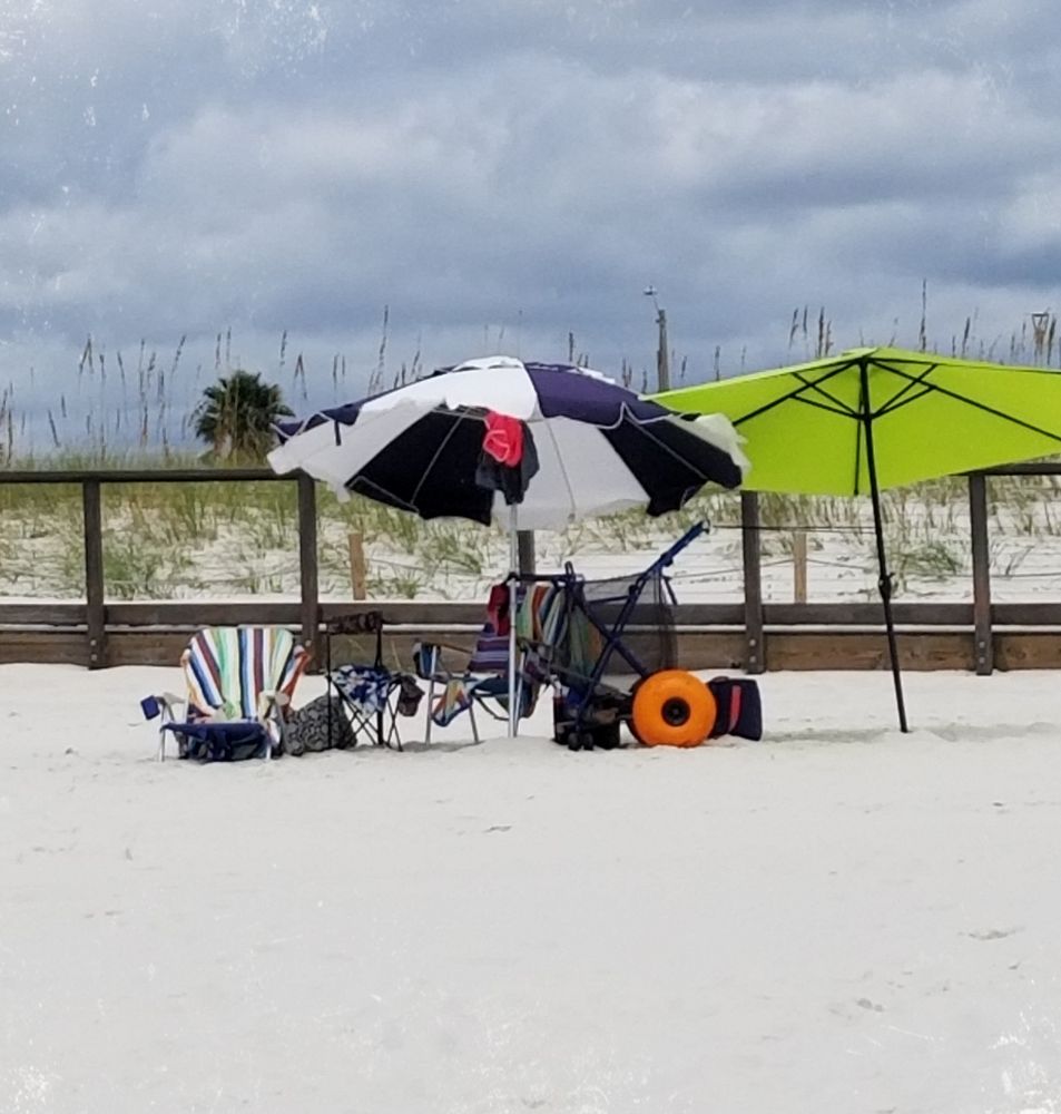 Cloudy beach day setup with wagon, umbrellas, chairs on white sandy beach.
Florida Panhandle, Gulf of Mexico