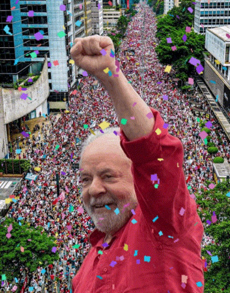 a man in a red shirt stands in front of a crowd of people