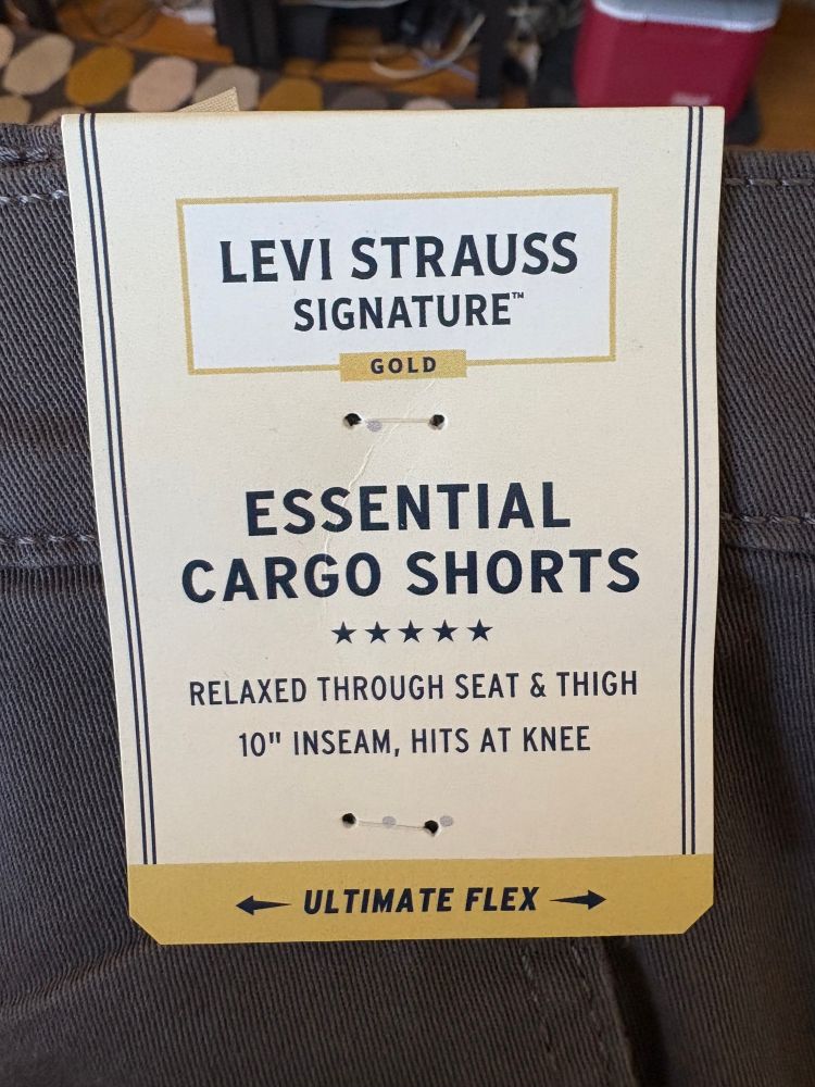 The tag on a pair of cargo shorts, which calls them "ESSENTIAL CARGO SHORTS"